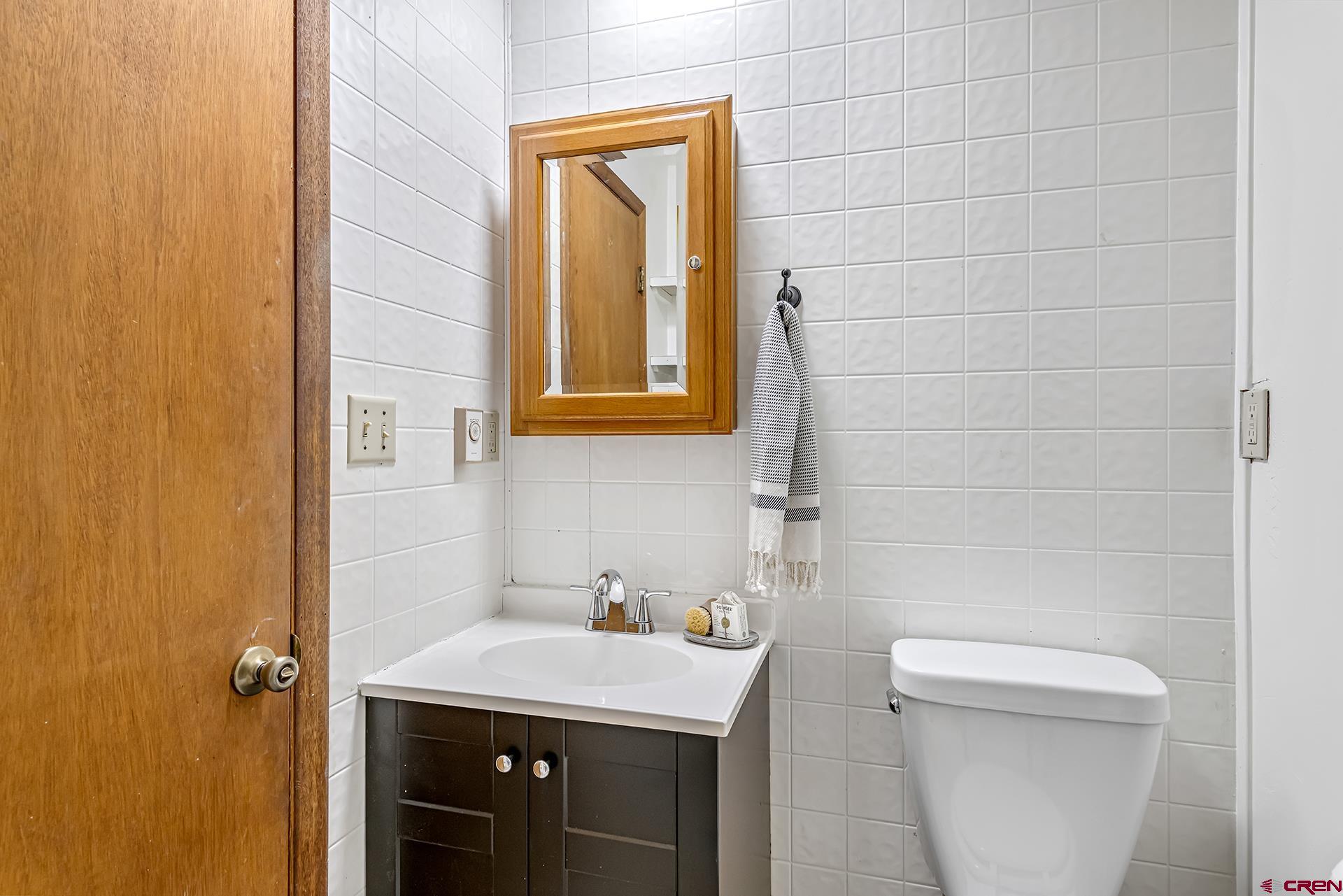 735 Howard Street Delta, CO 81416 - Photo 27 of 34 a bathroom with a sink a toilet and shower