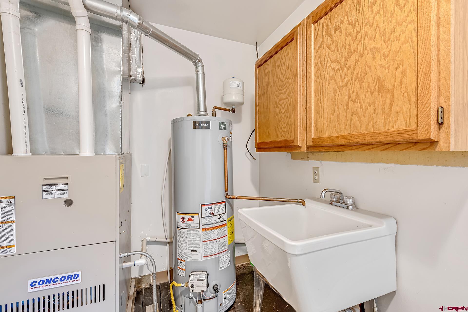 735 Howard Street Delta, CO 81416 - Photo 29 of 34 a bathroom with a sink a toilet and a shower curtain