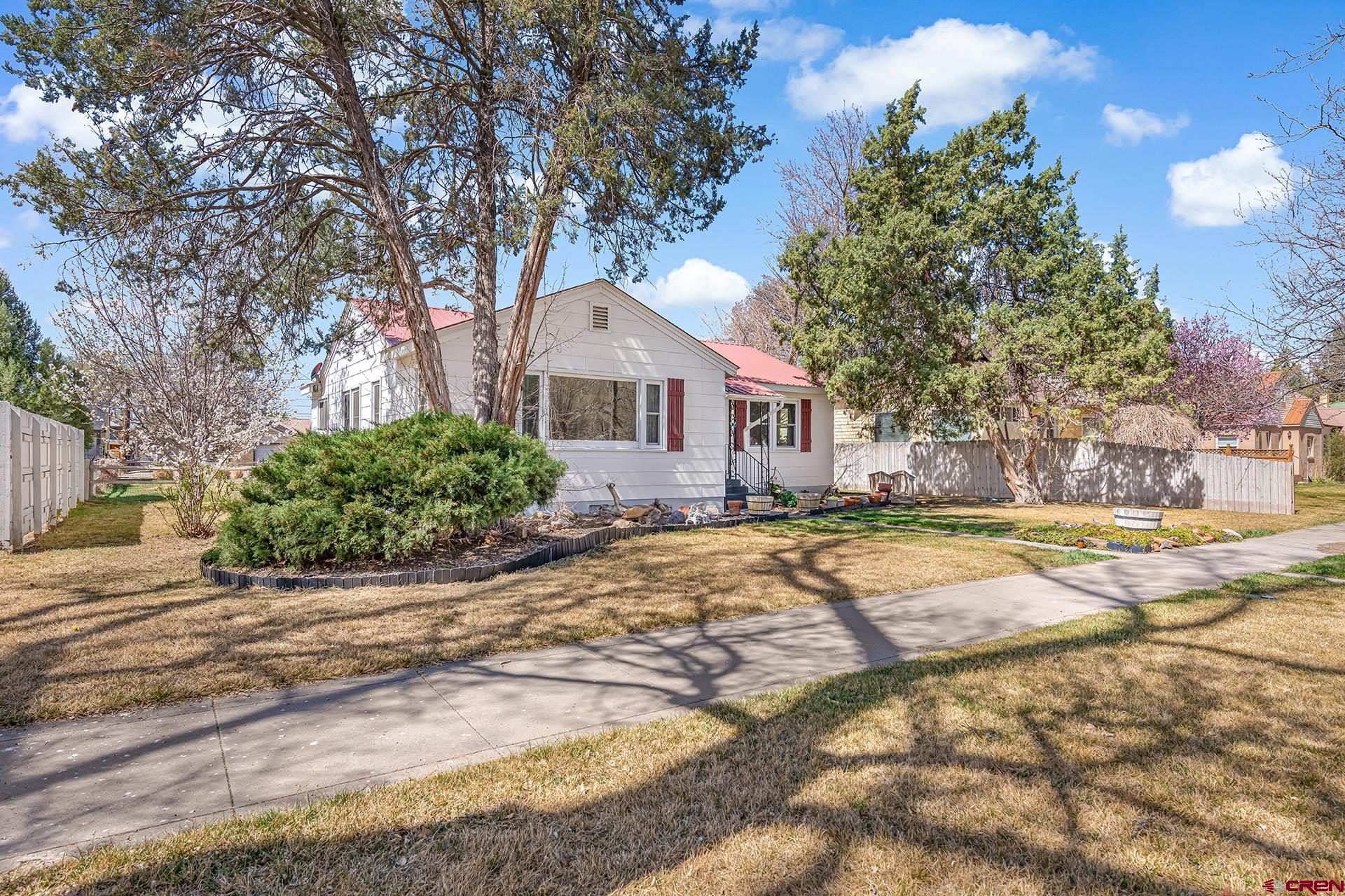 735 Howard Street Delta, CO 81416 - Photo 3 of 34 a view of a house with a swimming pool and sitting area