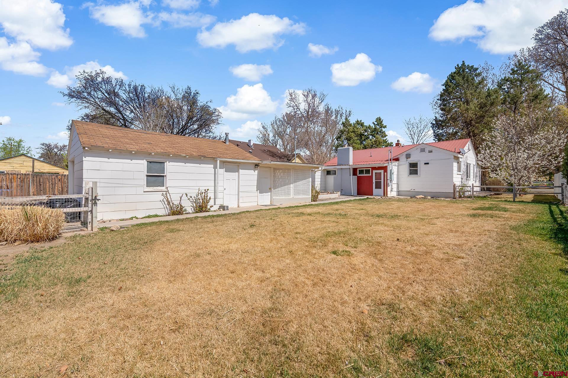 735 Howard Street Delta, CO 81416 - Photo 31 of 34 a backyard of a house with table and chairs