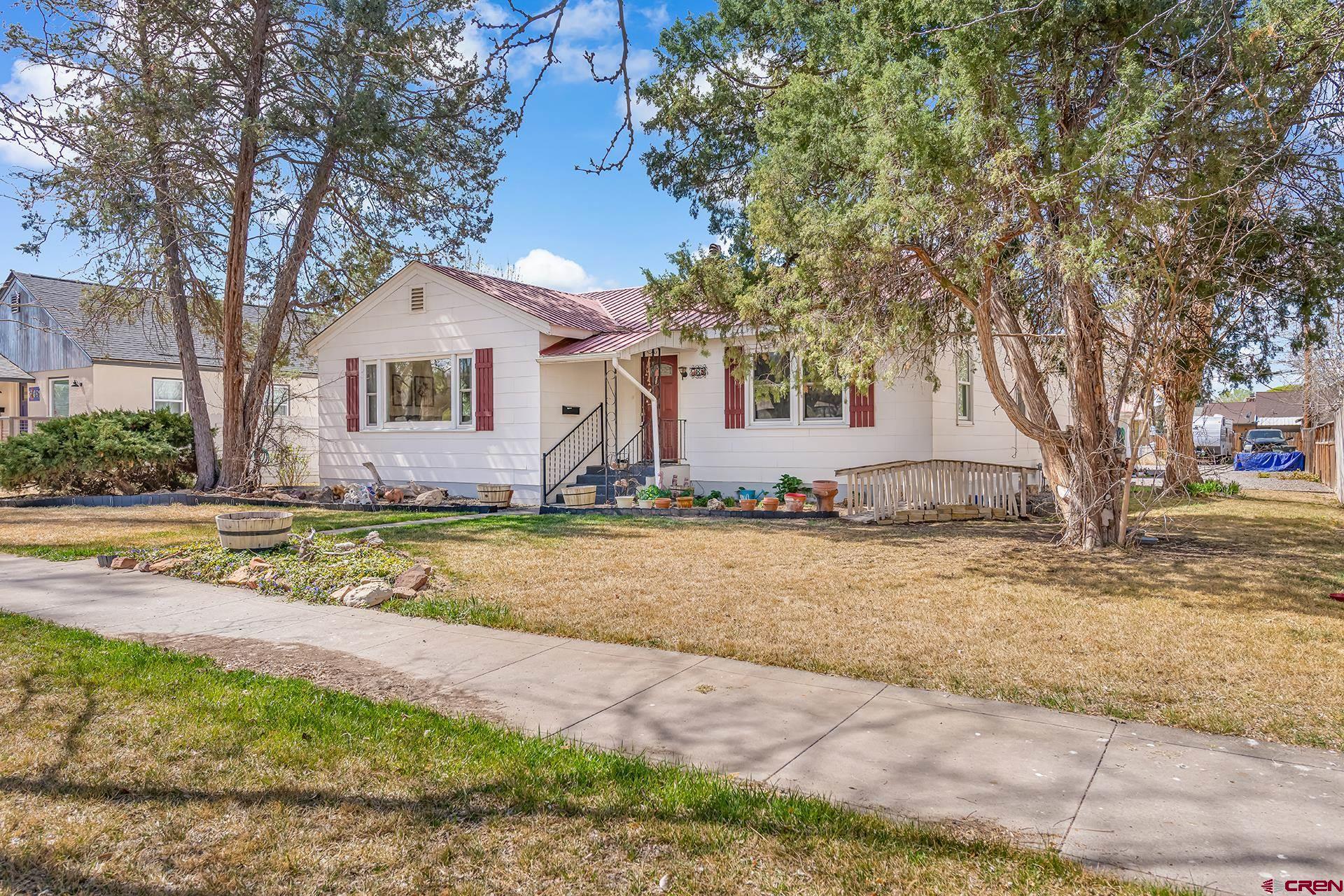735 Howard Street Delta, CO 81416 - Photo 4 of 34 a view of the house with snow on the road