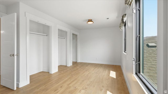2038 East Ranch Road Eagle Mountain, UT 84005 - Photo 28 of 66 Bright room with wood-finish flooring, multiple closet spaces, and large windows