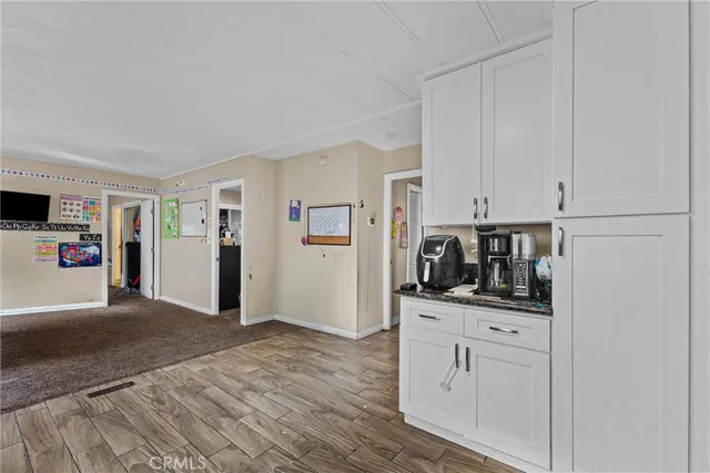 a kitchen with stainless steel appliances white cabinets and a refrigerator