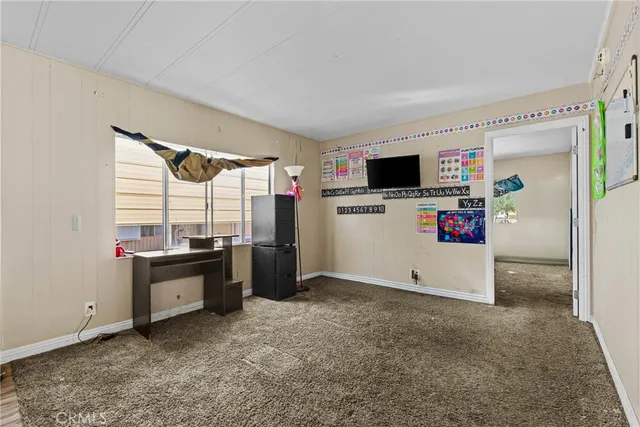 a view of work space with furniture and windows