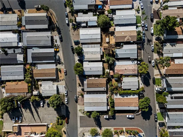 an aerial view of a houses with street