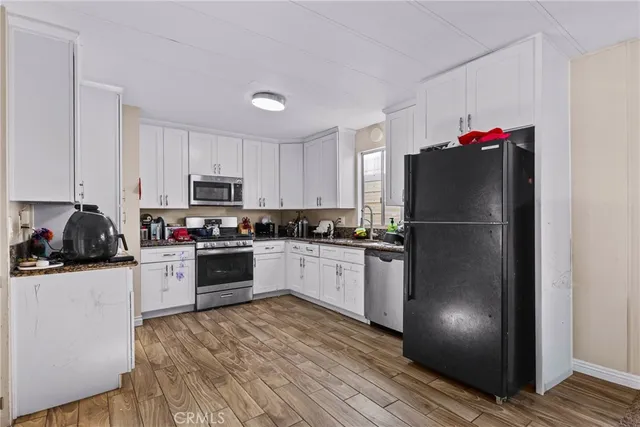 a kitchen with a refrigerator and a stove top oven