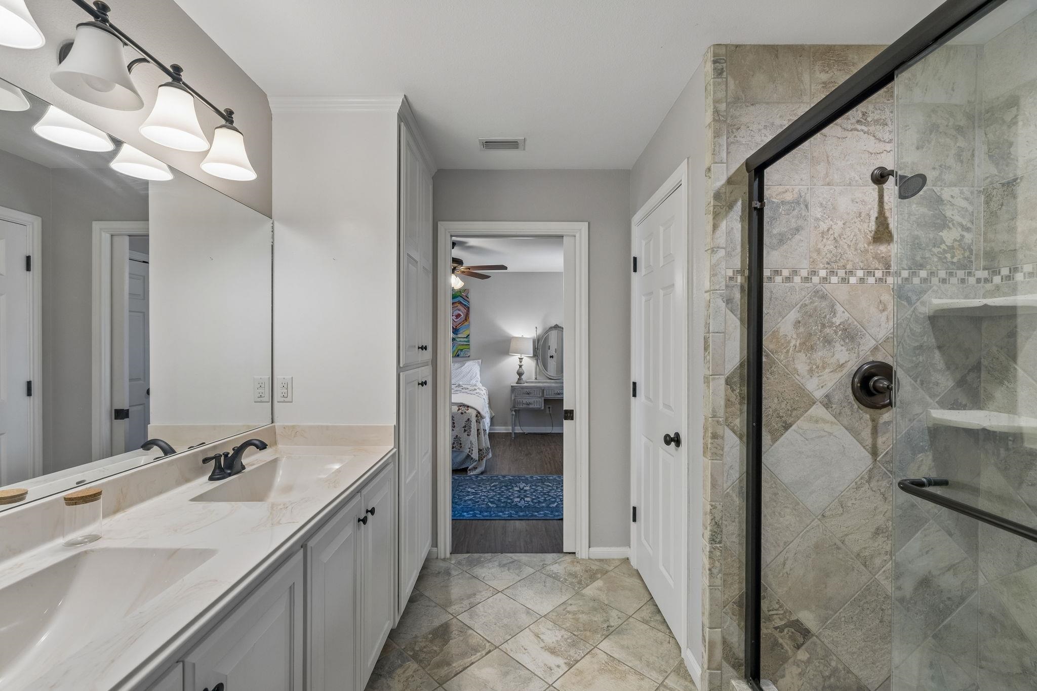 146 Antelope Lane Seguin, TX 78155 - Photo 22 of 28 a spacious bathroom with a shower sink and mirror