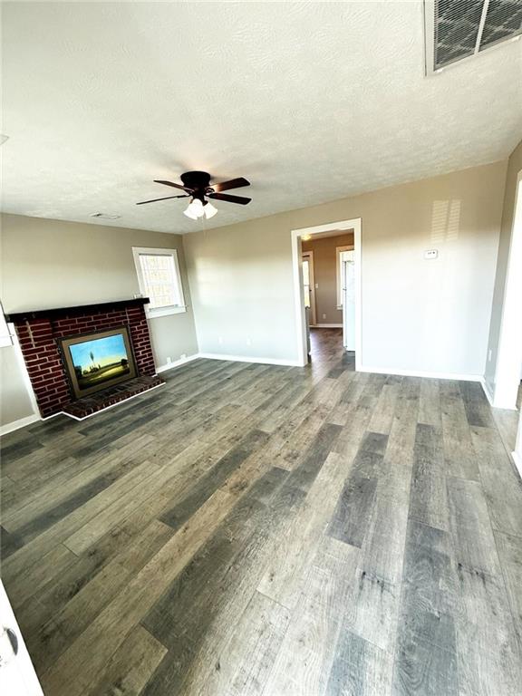 343 Chastain Mill Road Dawsonville, GA 30534 - Photo 2 of 12 a view of an empty room with a fireplace and a window