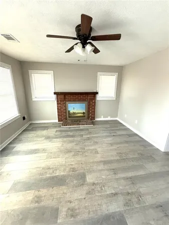 a view of empty room with a ceiling fan and window
