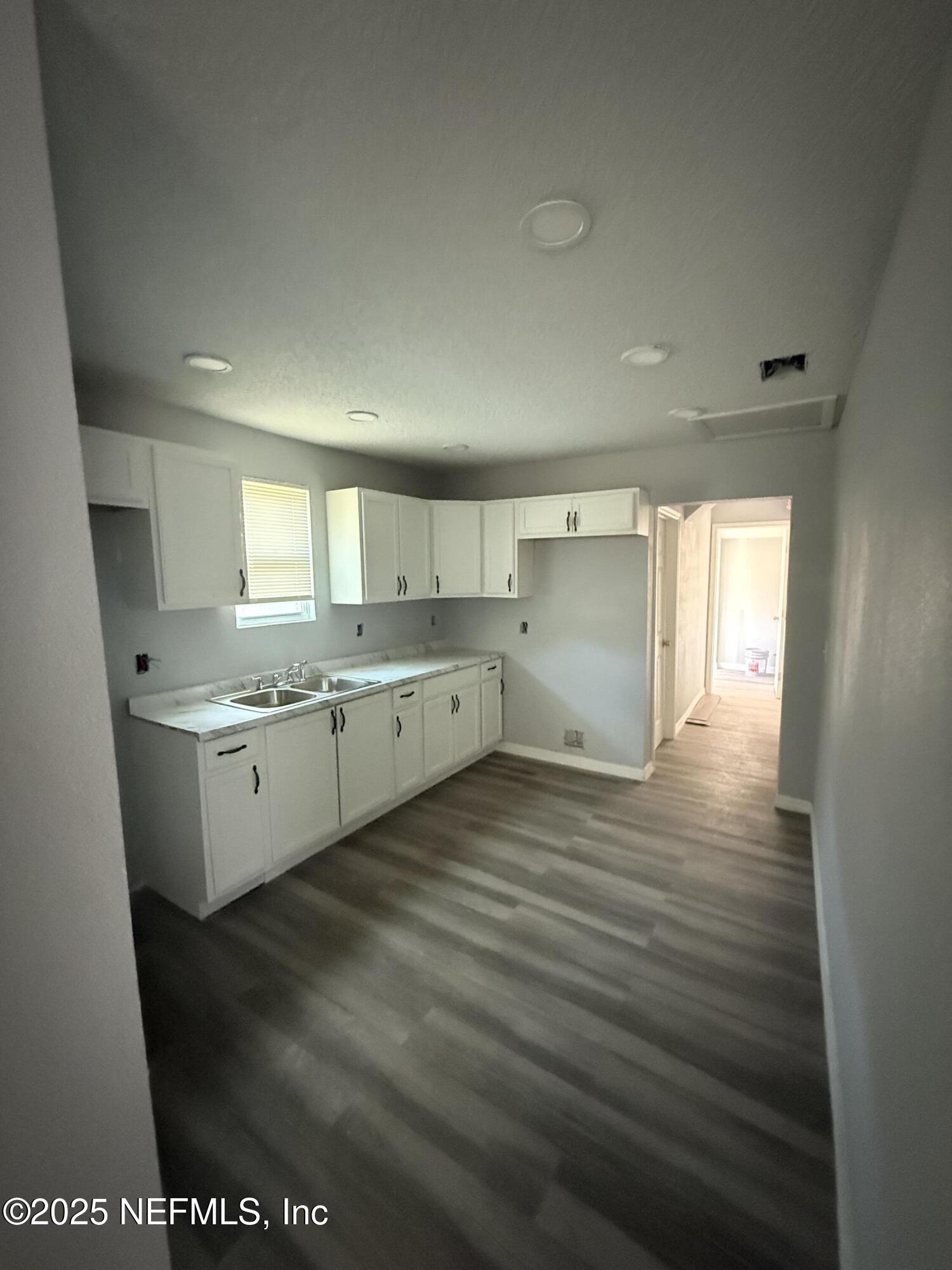 830 Rushing Street Jacksonville, FL 32209 - Photo 3 of 6 a large white kitchen with a white countertops cabinets and a sink