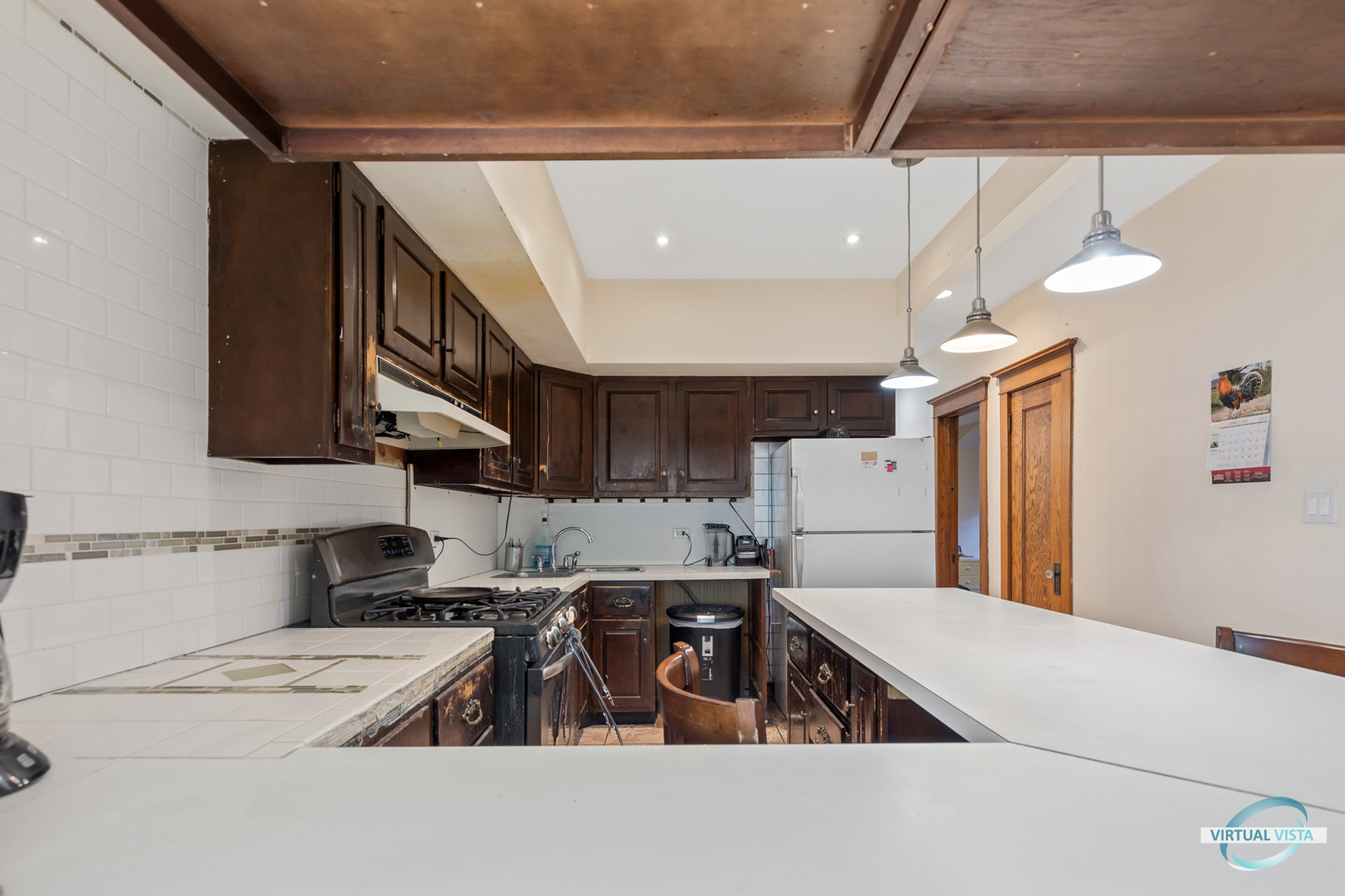 1521 North Springfield Avenue Chicago, IL 60651 - Photo 15 of 40 a kitchen with a sink a refrigerator and a stove top oven