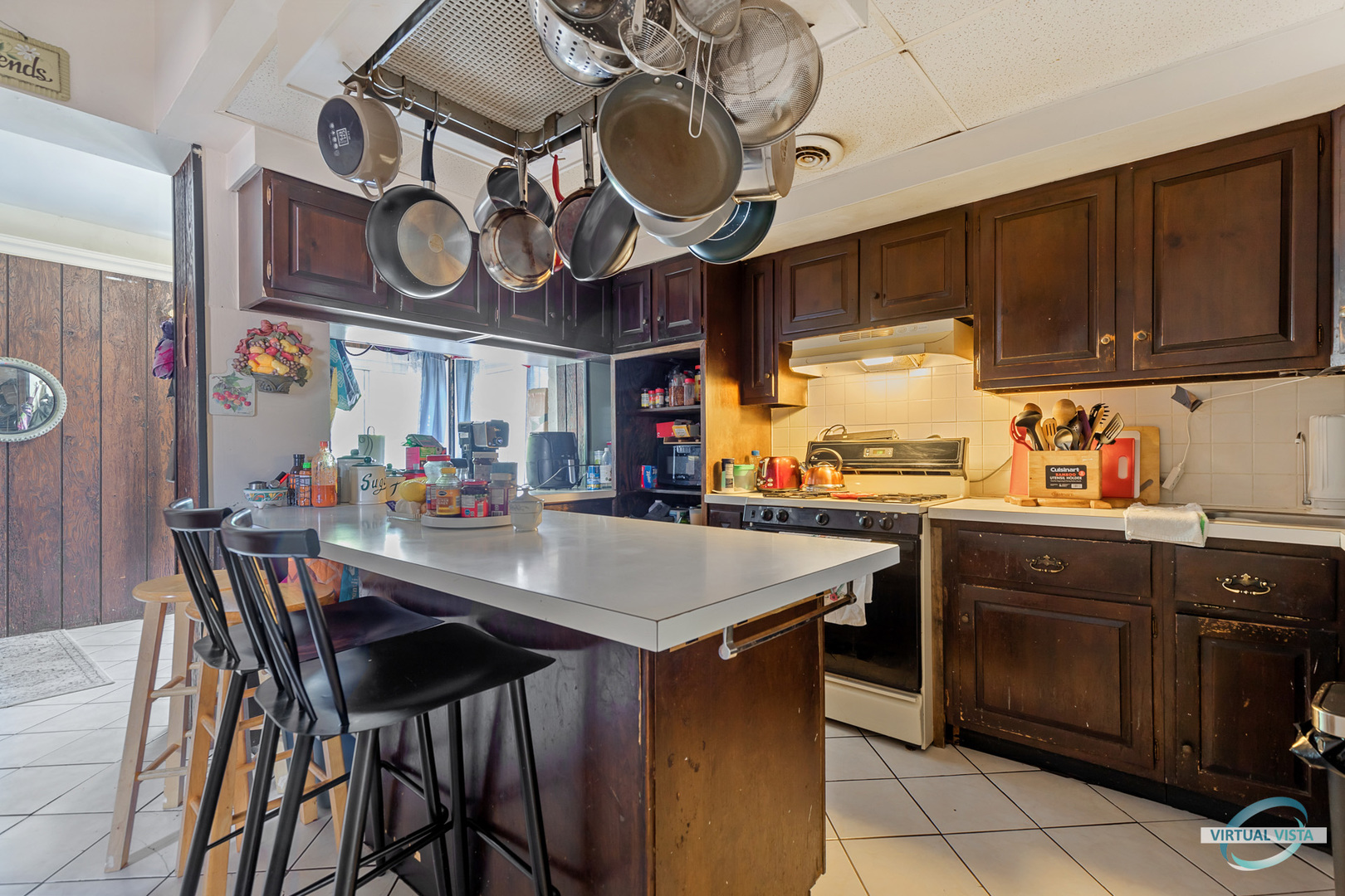 1521 North Springfield Avenue Chicago, IL 60651 - Photo 21 of 40 a kitchen with a large island with stainless steel appliances granite countertop a stove a sink dishwasher and cabinets with wooden cabinets