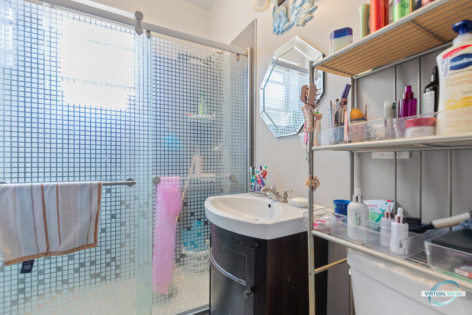 1521 North Springfield Avenue Chicago, IL 60651 - Photo 33 of 40 a bathroom with a sink a mirror and shower