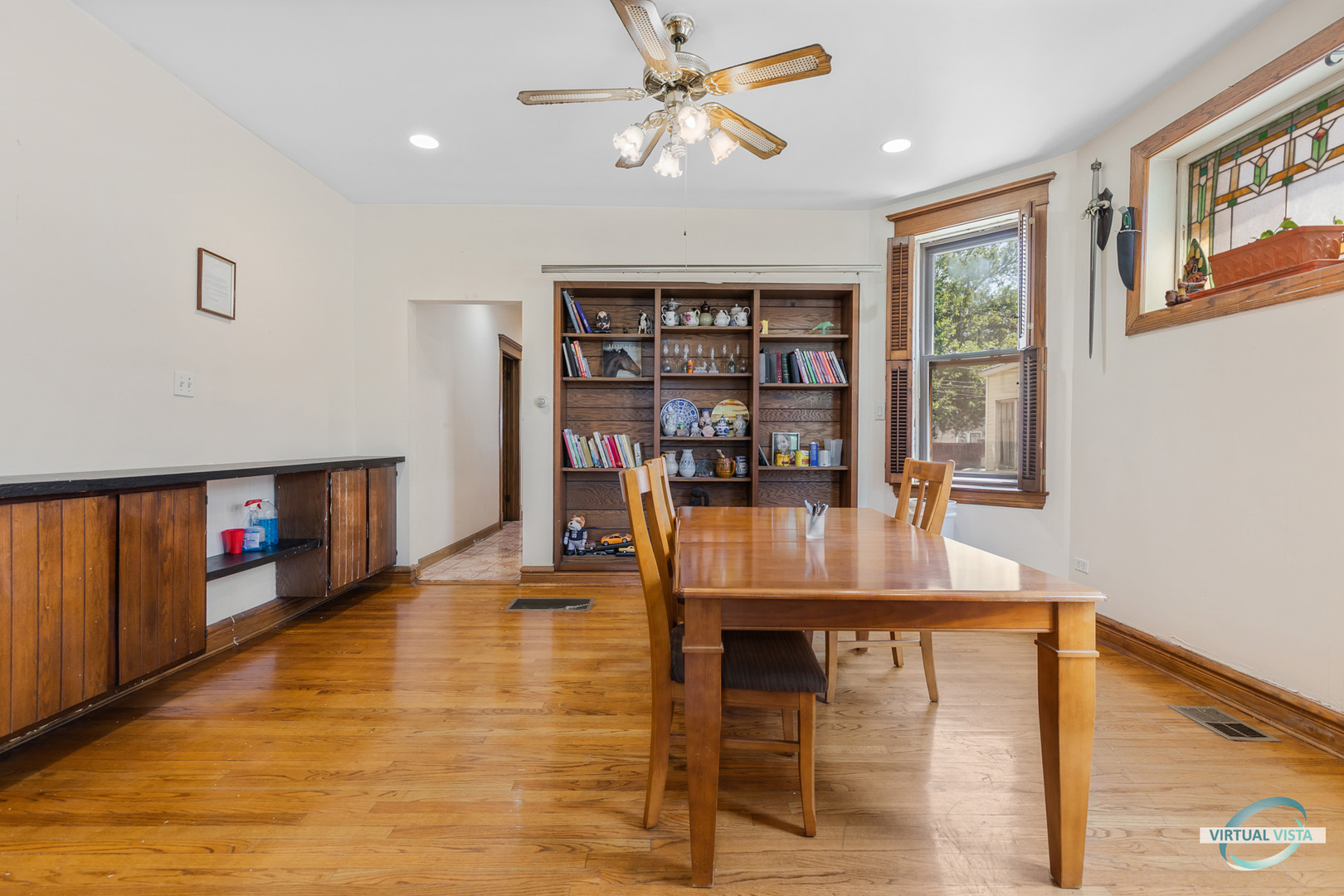 1521 North Springfield Avenue Chicago, IL 60651 - Photo 5 of 40 a view of a dining room with furniture and a book shelf