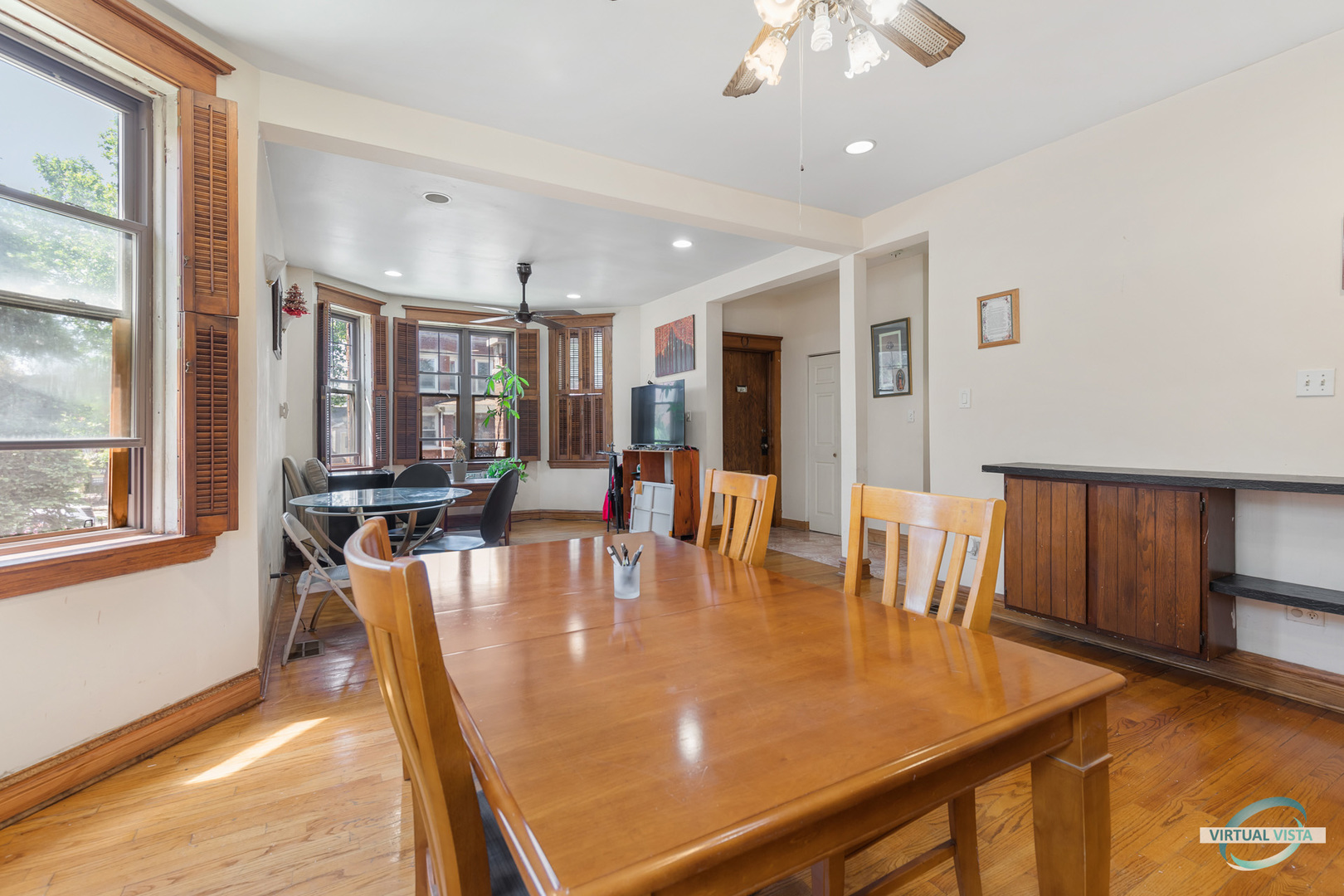 1521 North Springfield Avenue Chicago, IL 60651 - Photo 6 of 40 a dining room with wooden floor and chandelier