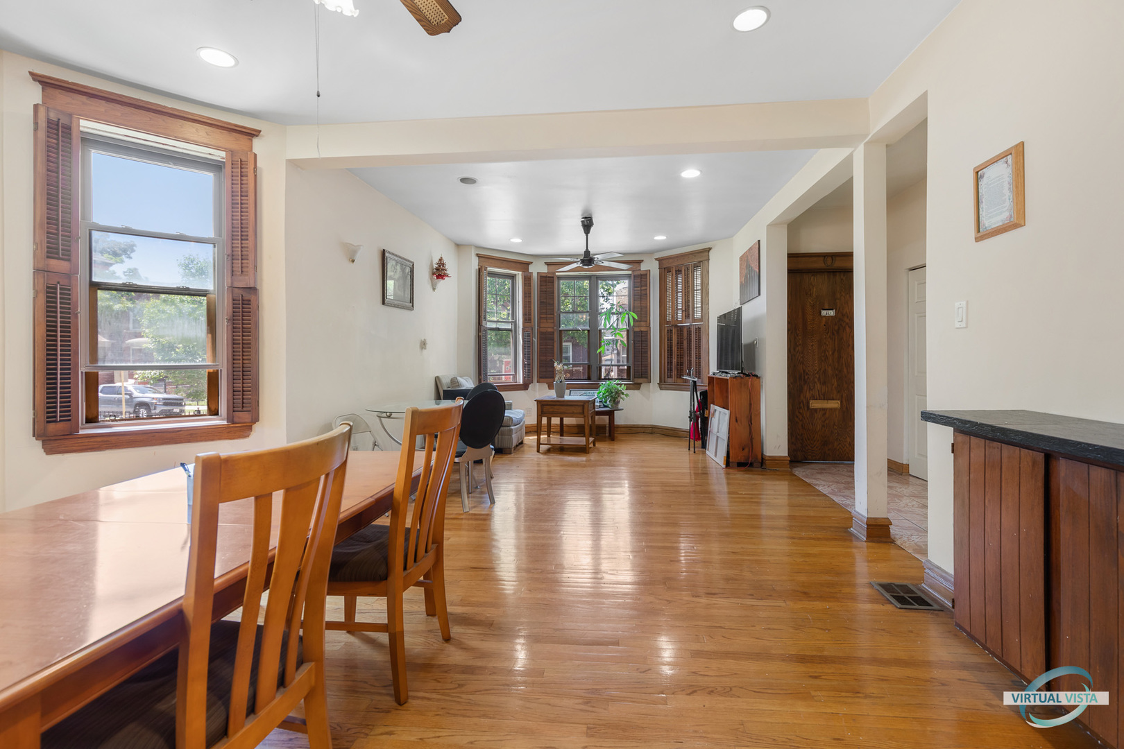 1521 North Springfield Avenue Chicago, IL 60651 - Photo 8 of 40 a view of a dining room and livingroom with furniture wooden floor a chandelier