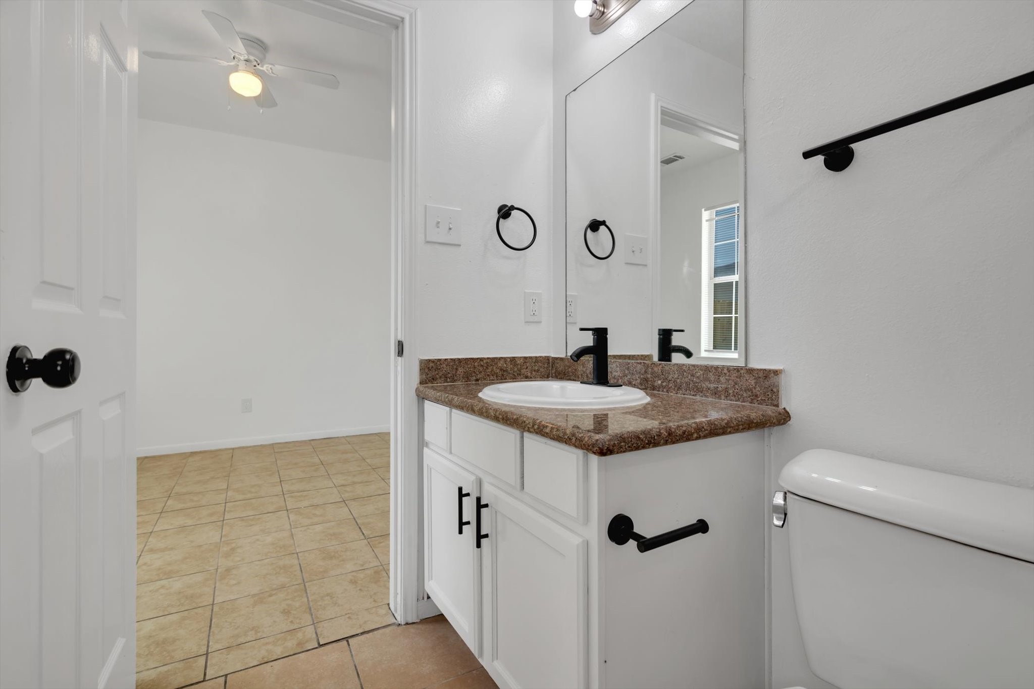 6933 Liverpool Street, Unit A Houston, TX 77021 - Photo 13 of 49 a bathroom with a granite countertop sink a toilet and shower