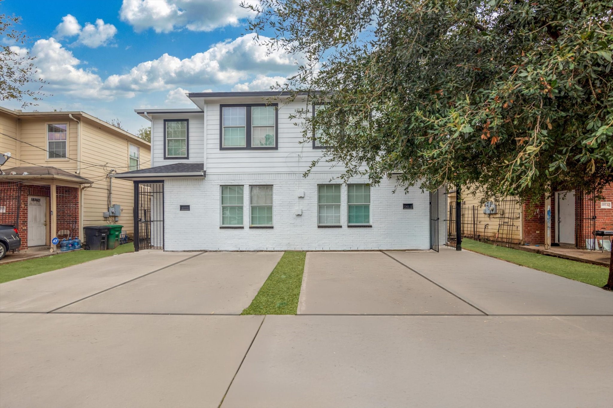 6933 Liverpool Street, Unit A Houston, TX 77021 - Photo 2 of 49 a front view of a house with a yard and garage
