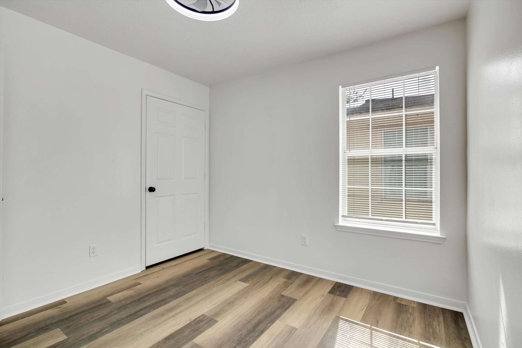 6933 Liverpool Street, Unit A Houston, TX 77021 - Photo 32 of 49 a view of an empty room with wooden floor and a window