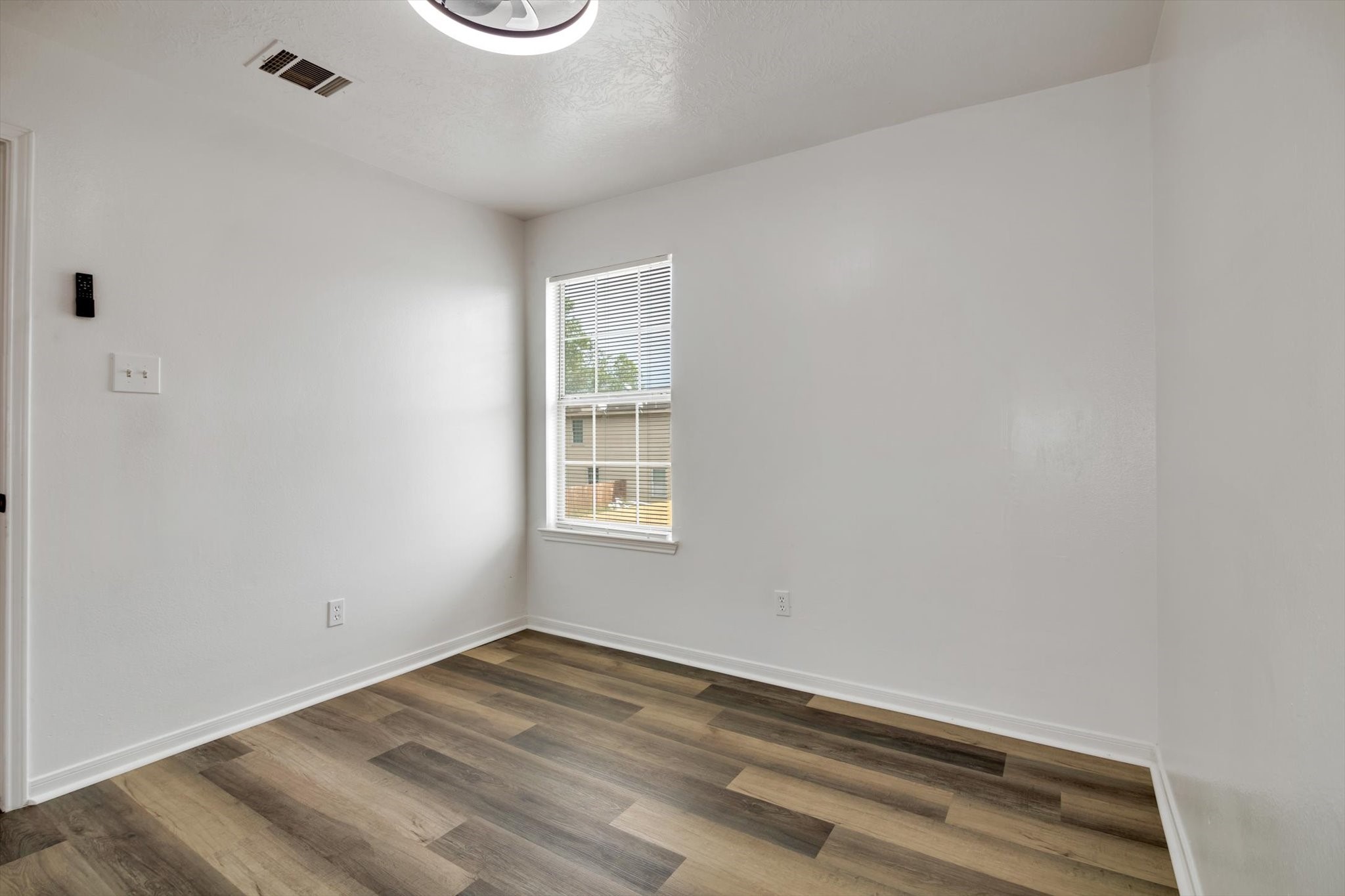 6933 Liverpool Street, Unit A Houston, TX 77021 - Photo 33 of 49 an empty room with wooden floor and windows