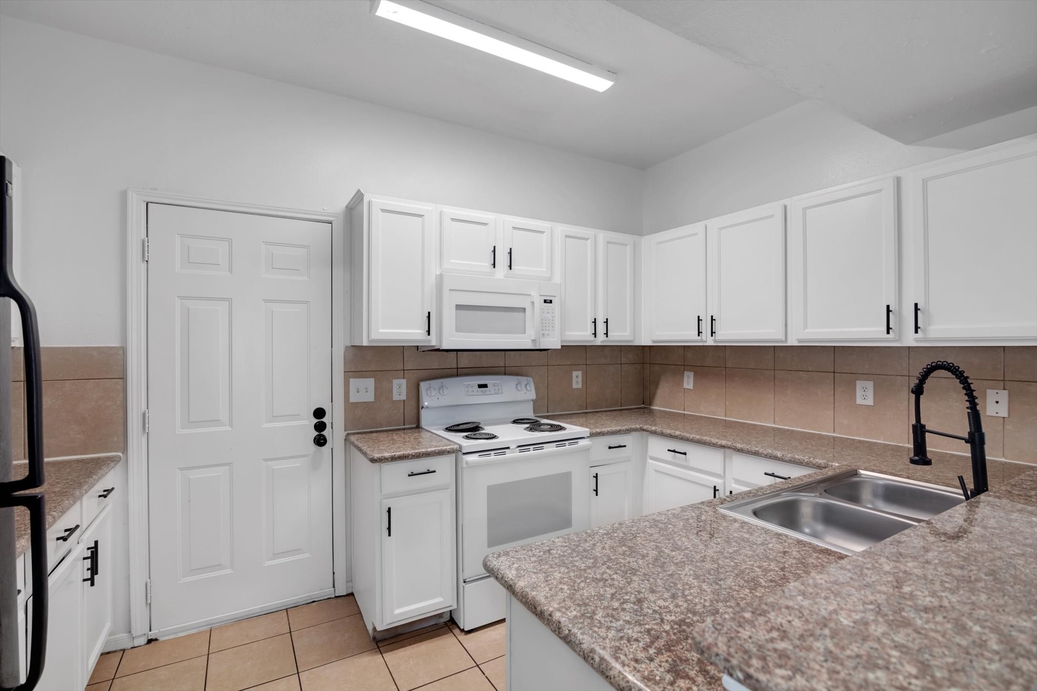 6933 Liverpool Street, Unit A Houston, TX 77021 - Photo 37 of 49 a kitchen with stainless steel appliances granite countertop a sink stove and refrigerator