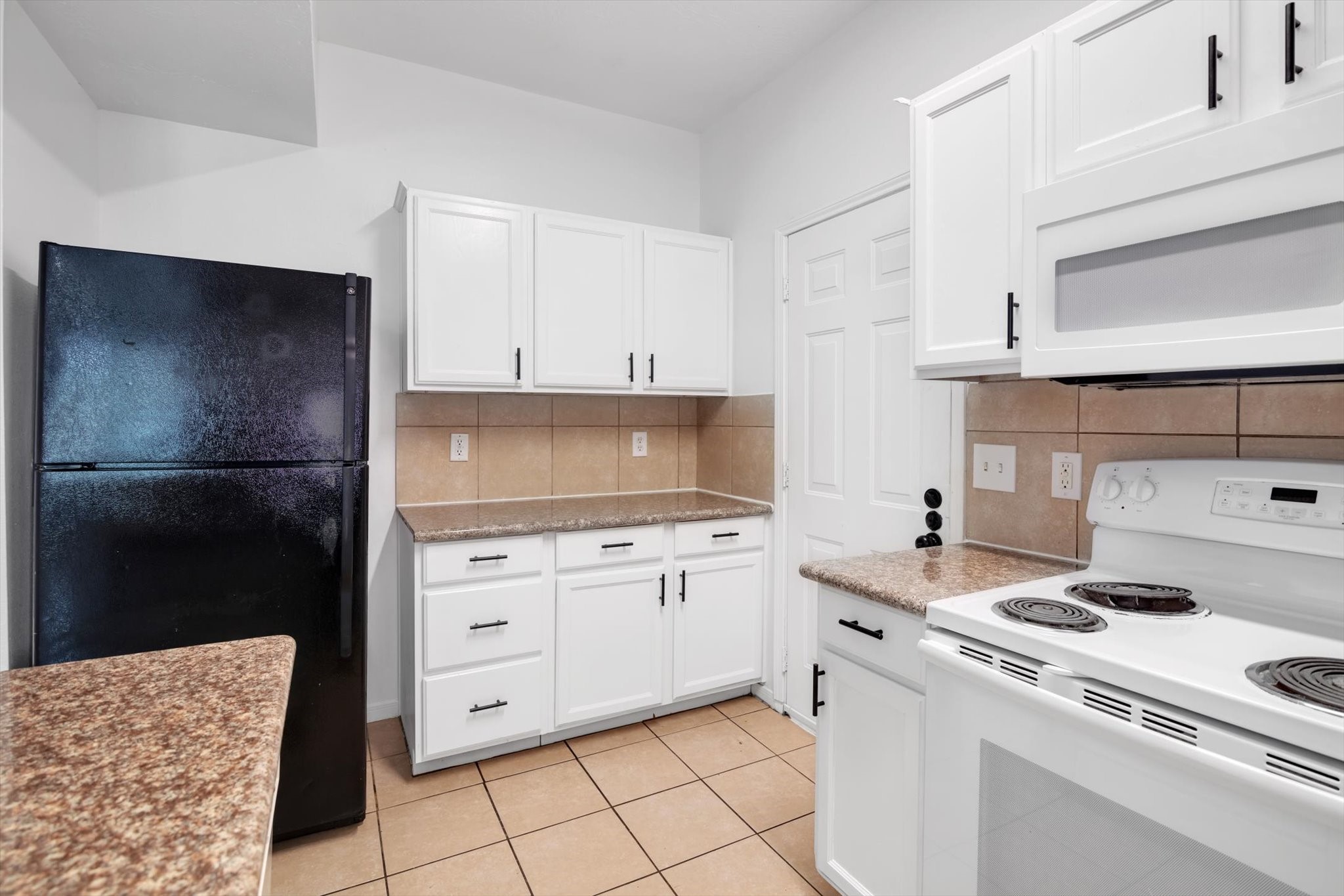 6933 Liverpool Street, Unit A Houston, TX 77021 - Photo 39 of 49 a kitchen with white cabinets and appliances