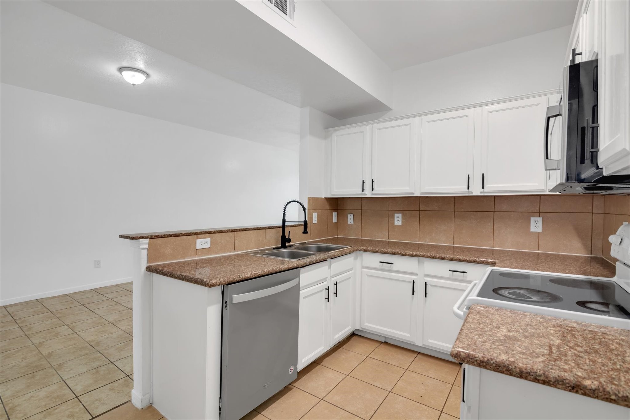 6933 Liverpool Street, Unit A Houston, TX 77021 - Photo 4 of 49 a kitchen with a sink stove and cabinets