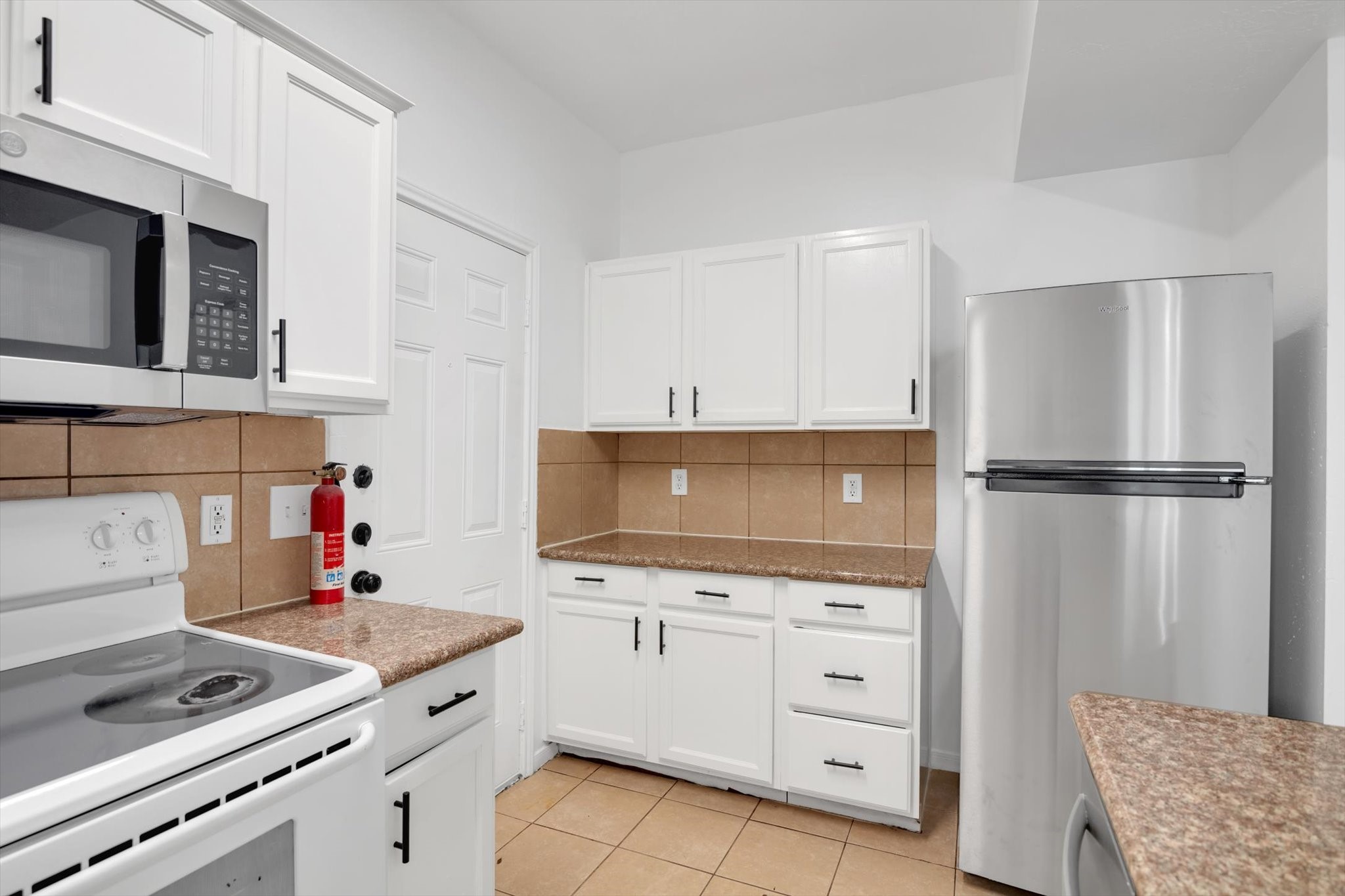 6933 Liverpool Street, Unit A Houston, TX 77021 - Photo 7 of 49 a kitchen with white cabinets and appliances