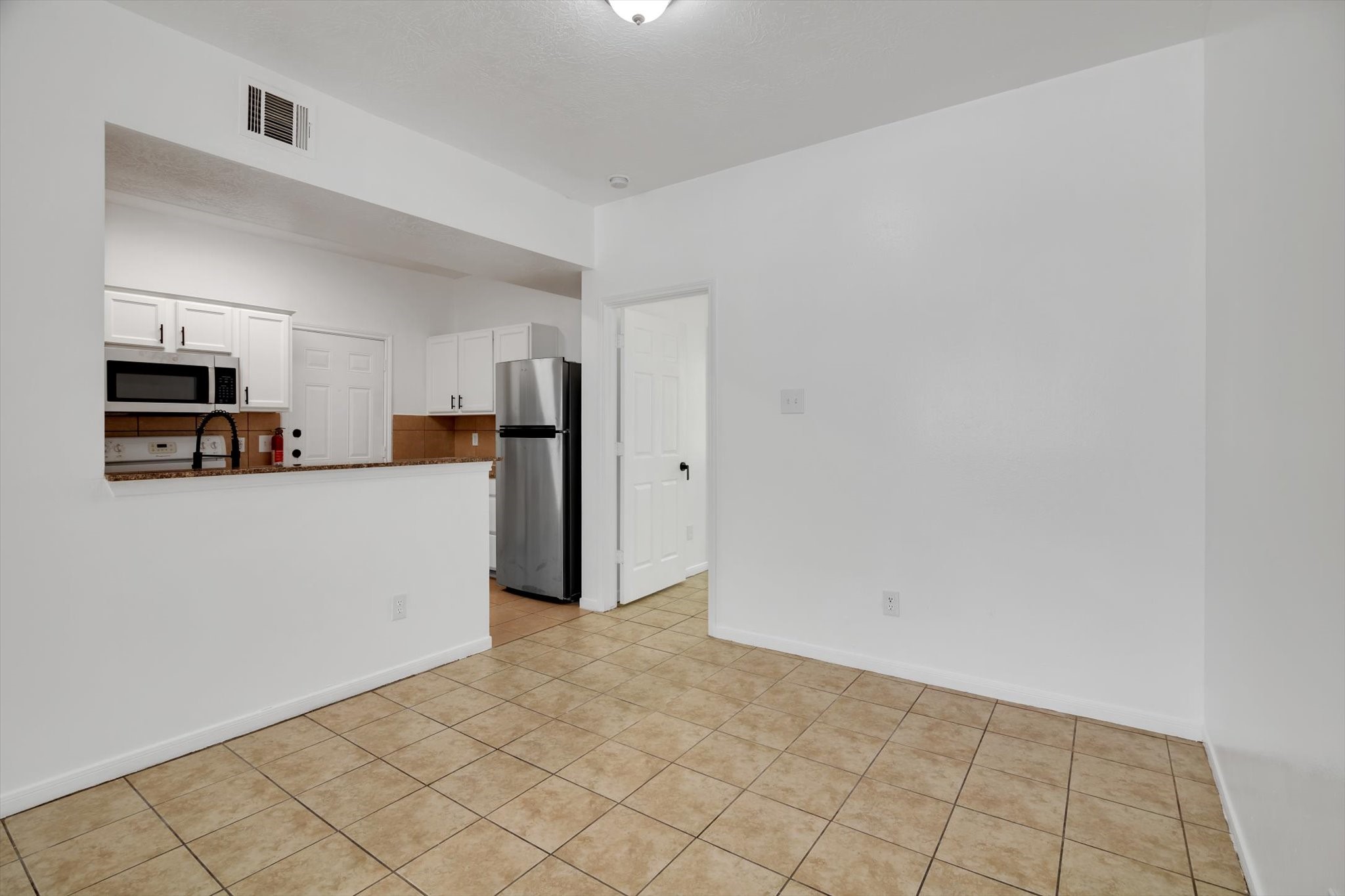 6933 Liverpool Street, Unit A Houston, TX 77021 - Photo 9 of 49 a view of a kitchen with refrigerator and microwave