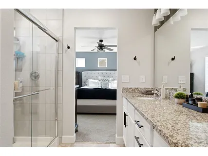 a en suite bathroom with a double sink shower and a mirror