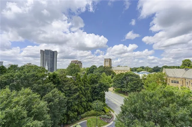 a living room with furniture fireplace and a large window