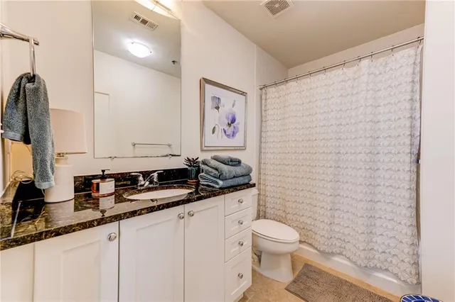 a white toilet sitting next to a white wall