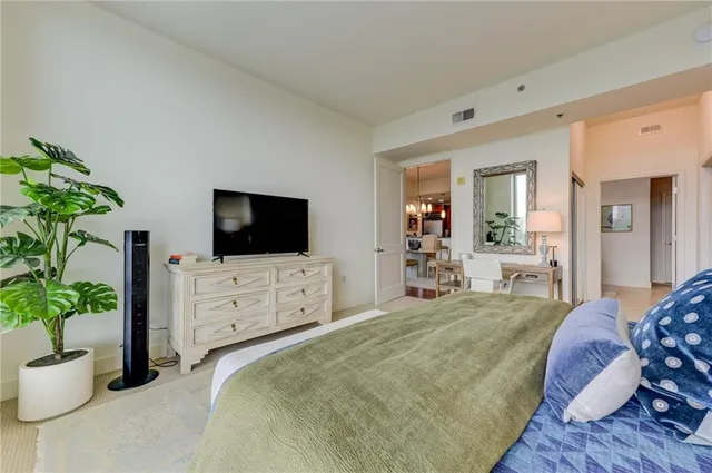 a bedroom with a bed and flat screen tv