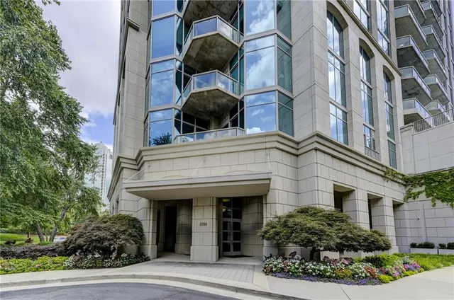 front view of a building with a tree