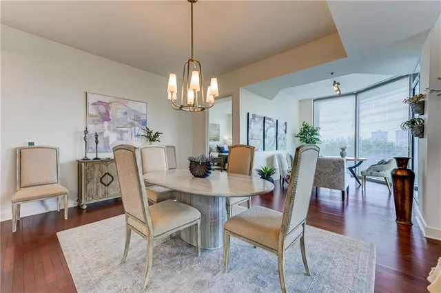 a view of a dining room with furniture wooden floor and chandelier