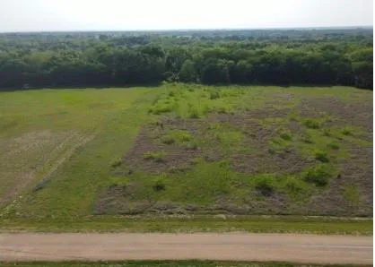 a view of a field with an ocean