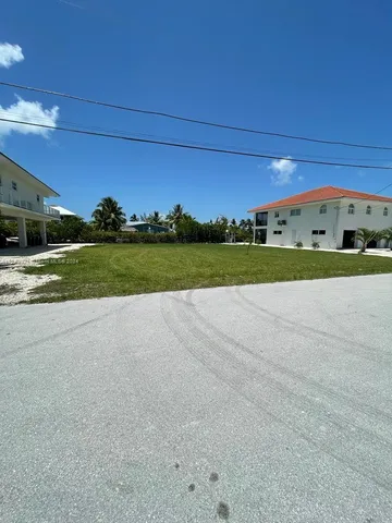 a view of a field of grass and trees