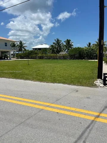 a view of a swimming pool and a yard