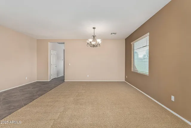 an empty room with fan and windows