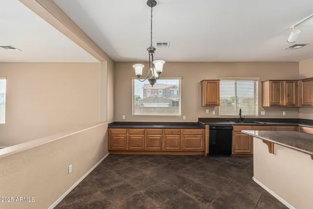 a view of a room with a ceiling fan and a window