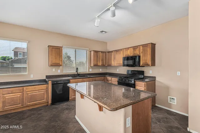 a bathroom with a double vanity sink a mirror and a bathtub