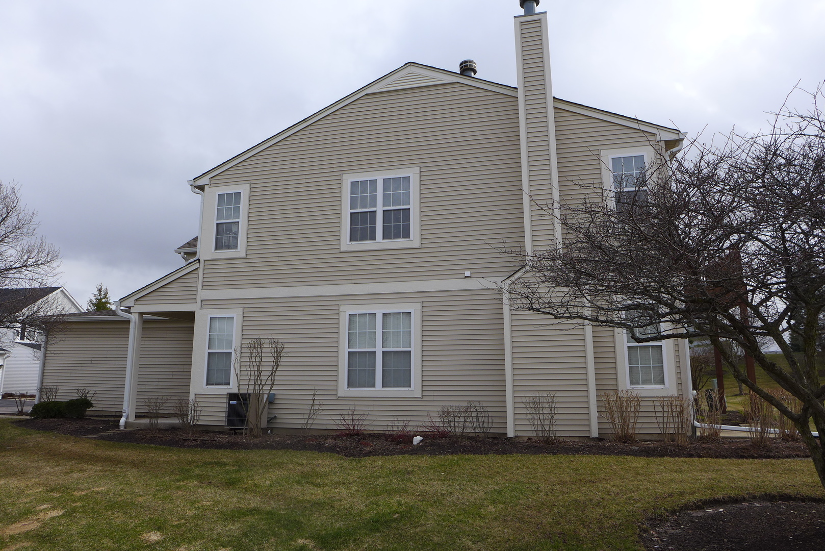 3076 Falling Waters Lane Lindenhurst, IL 60046 - Photo 2 of 15 a front view of a house with a yard
