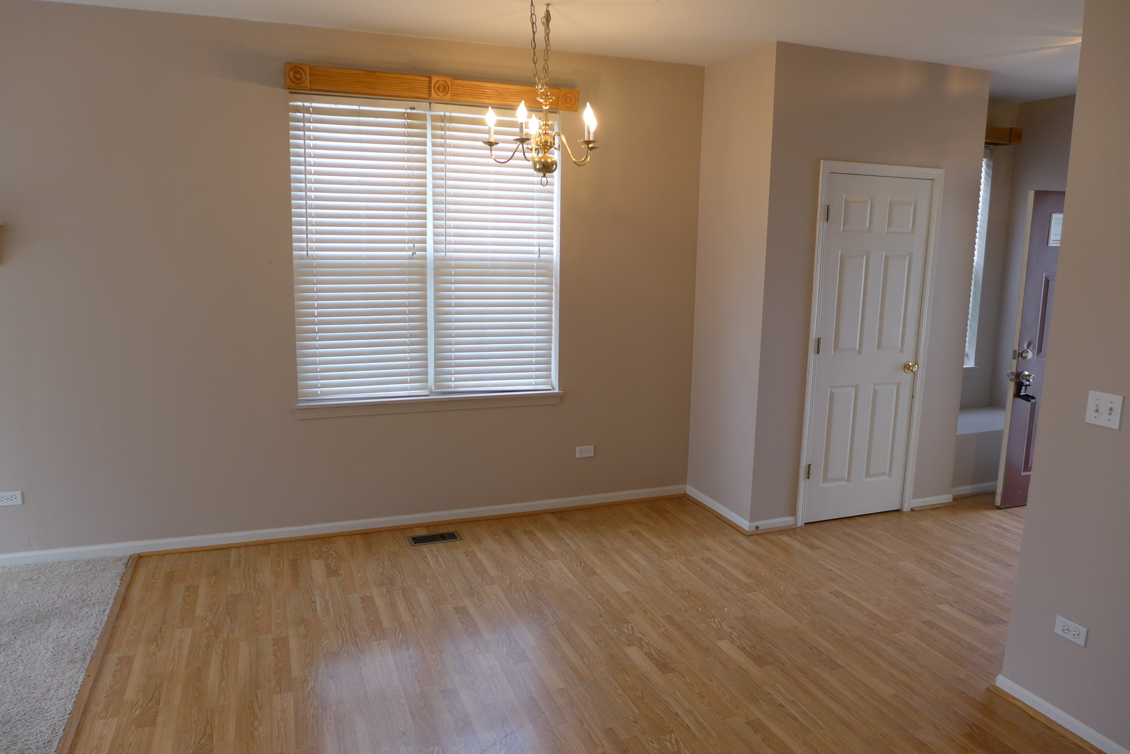3076 Falling Waters Lane Lindenhurst, IL 60046 - Photo 7 of 15 a view of an empty room with wooden floor and a window
