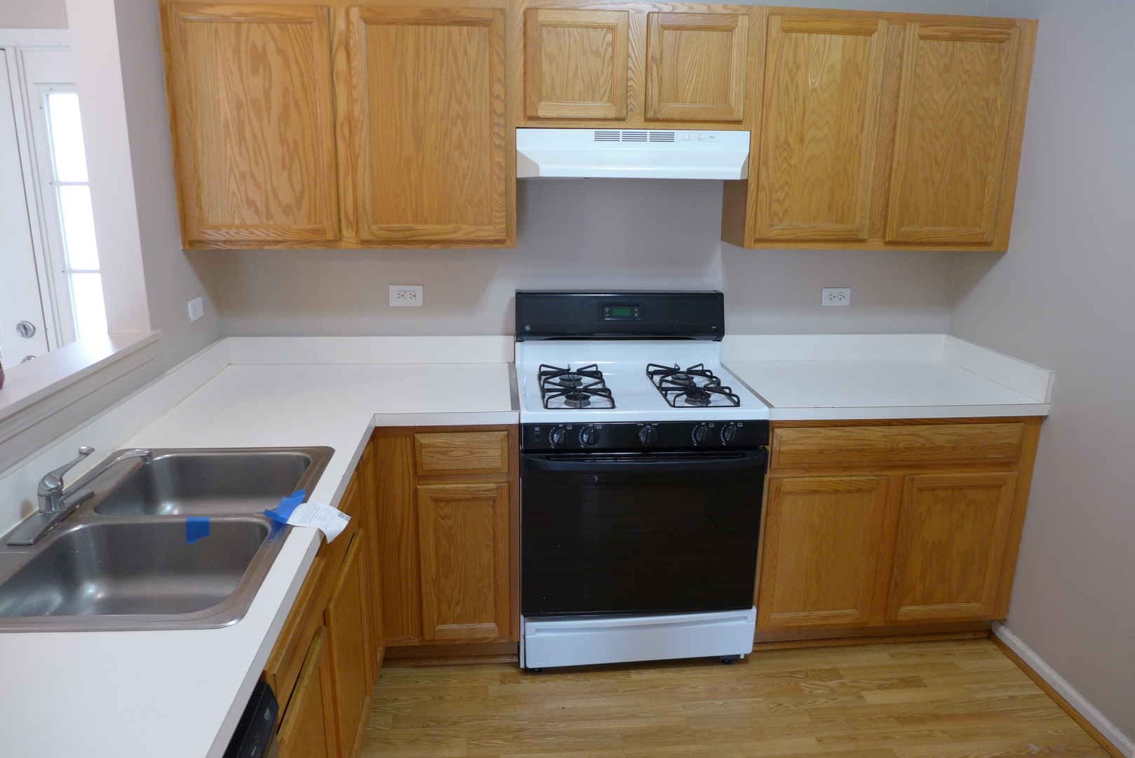 3076 Falling Waters Lane Lindenhurst, IL 60046 - Photo 8 of 15 a kitchen with a sink and a stove top oven