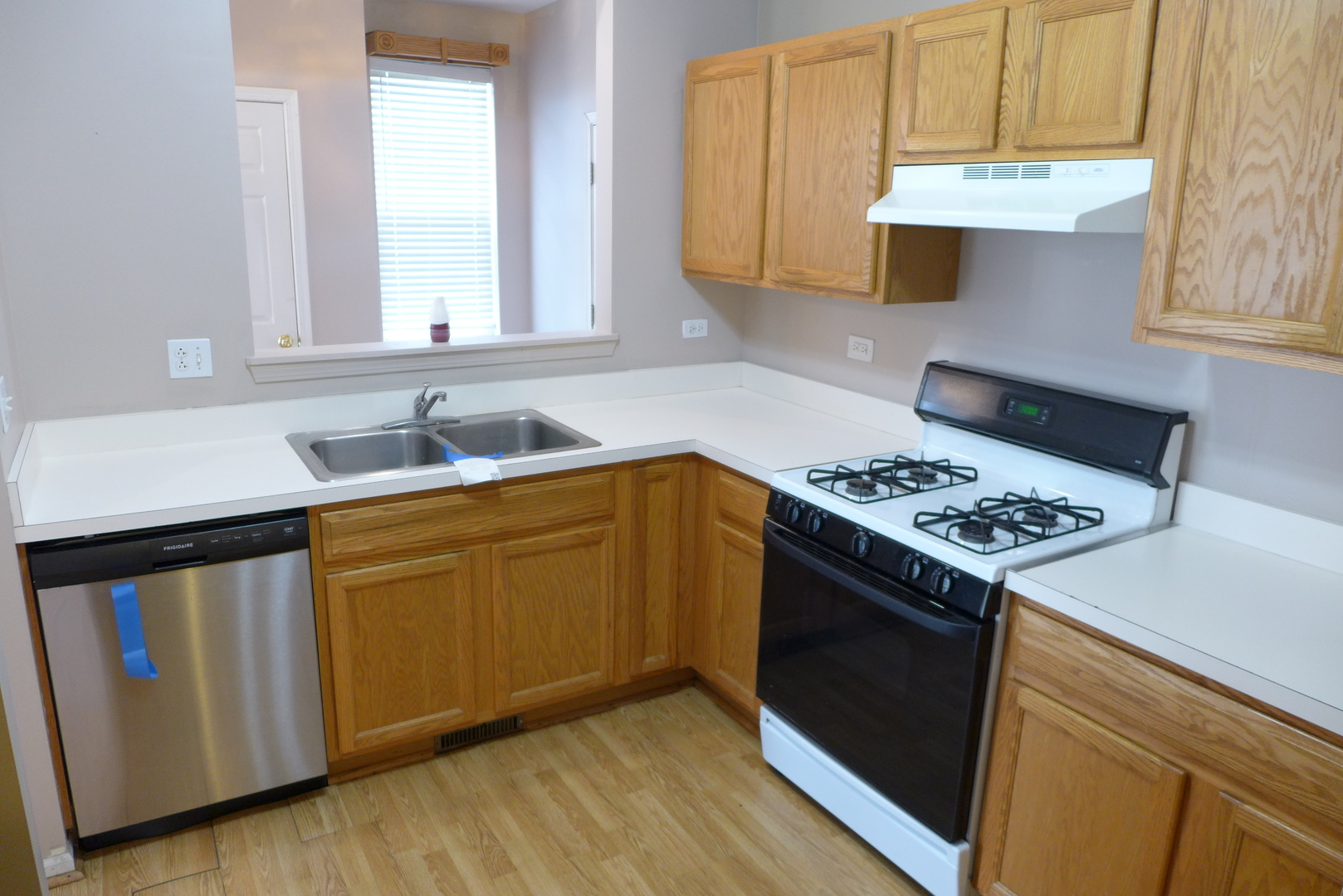 3076 Falling Waters Lane Lindenhurst, IL 60046 - Photo 9 of 15 a kitchen with a sink stove and cabinets
