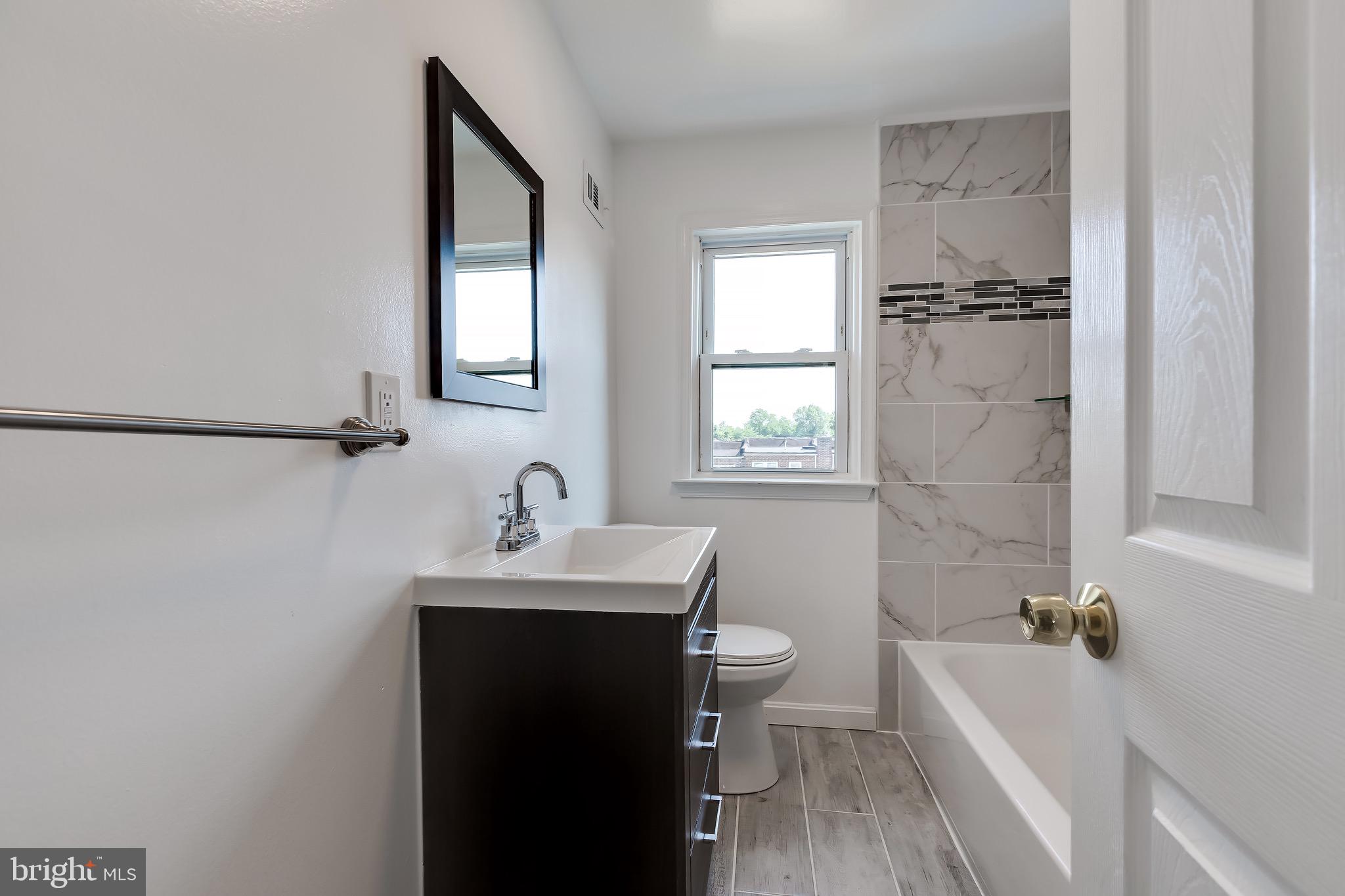 228 West Edgevale Road Baltimore, MD 21225 - Photo 21 of 39 Upper-level bathroom with modern updates.