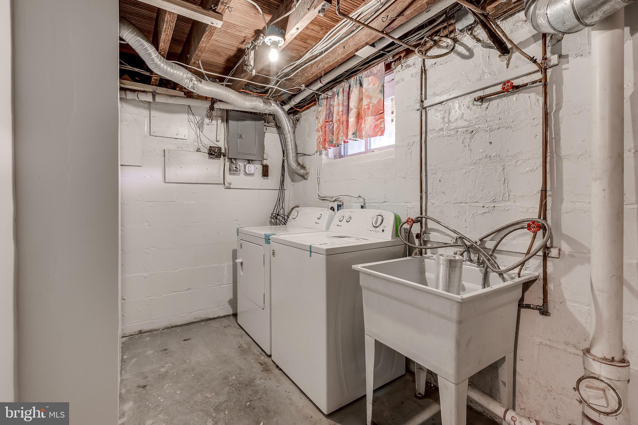 228 West Edgevale Road Baltimore, MD 21225 - Photo 34 of 39 Utility Room with Side by Side Washer/Dryer