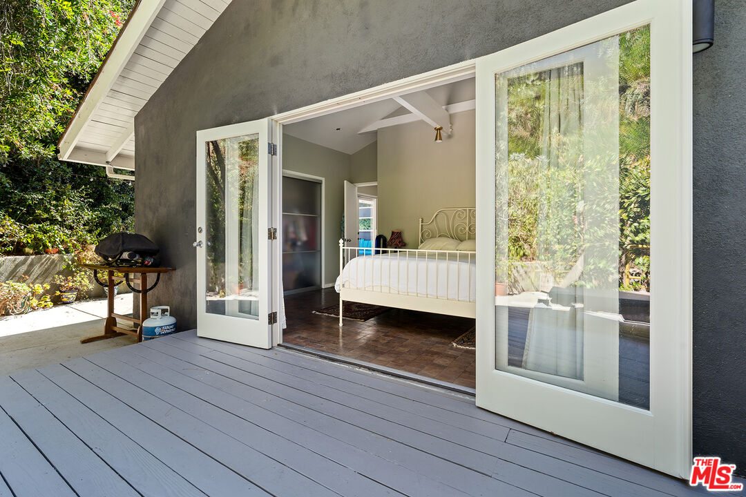 3775 Fredonia Drive Los Angeles, CA 90068 - Photo 12 of 16 a bedroom with a bed and wooden floor
