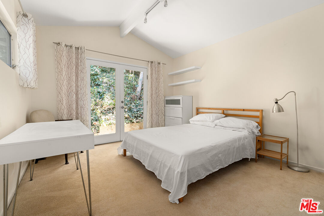 3775 Fredonia Drive Los Angeles, CA 90068 - Photo 13 of 16 a bedroom with a bed table and a window