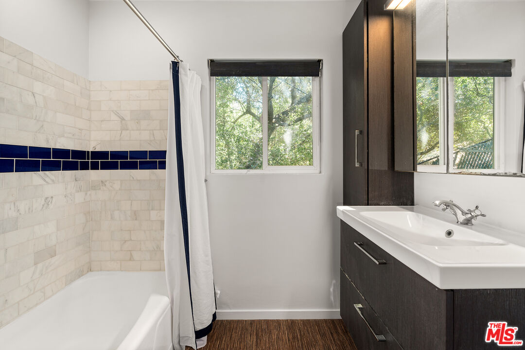 3775 Fredonia Drive Los Angeles, CA 90068 - Photo 14 of 16 a bathroom with a sink a mirror and a bathtub